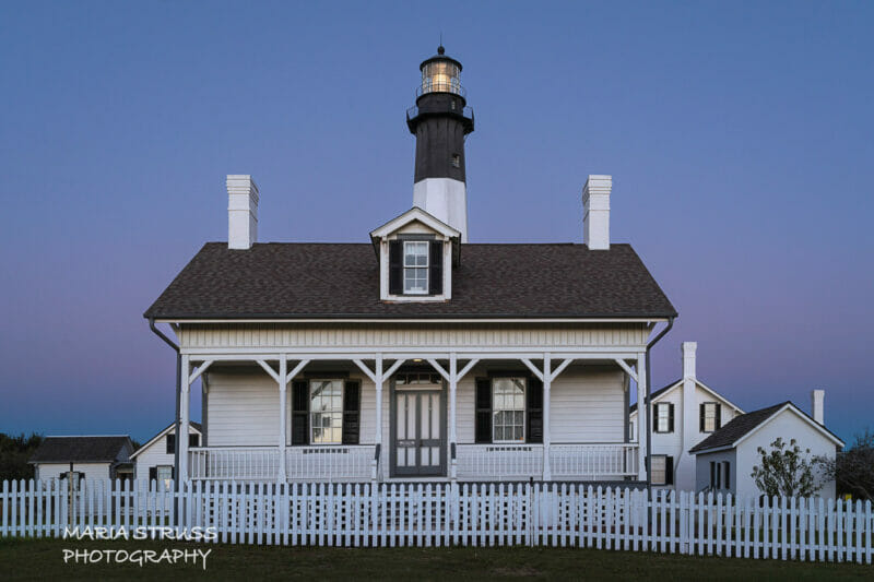 A photo of Tybee Island Lighthouse with the house in front.